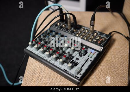 Portable audio device featuring labeled inputs and illumination. Compact and durable audio mixer designed for portability with clearly labeled Stock Photo