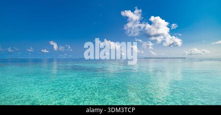 Tranquil panoramic ocean sunny blue sky clouds serene seascape horizon summer coastal background Stock Photo