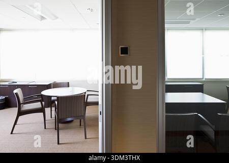 A modern, vacant office suite featuring an empty meeting table and professional chairs in West Hartford, Connecticut. Stock Photo