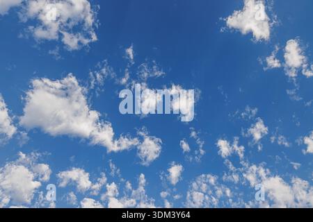 Sunny blue sky with fluffy white clouds natural skyscape background bright summer day atmospheric landscape outdoors Stock Photo