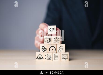 KPI key performance indicators concept for business strategy and performance measurement, wooden blocks with icons of analytics, goals and planning, Stock Photo