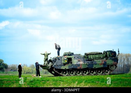 Military exercises and troop movements with heavy vehicles on the floodplains and dikes of the IJssel river near Deventer, Netherlands, in spring. Stock Photo