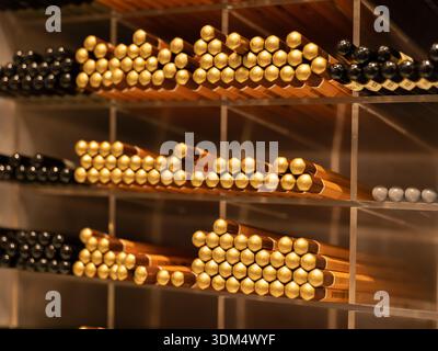 Golden and black pencils arranging on shelves in a stationery retail shop Stock Photo