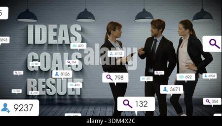 Discussing three colleagues in suits exchanging ideas at meeting, with tablet and graphic bubbles Stock Photo