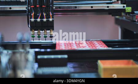 Pick and place robot machine assembling electronic circuit boards in factory Stock Photo