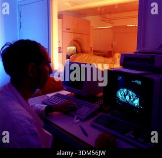 Radiographer conducting a computerised tomography (CT) scan for a patient. Stock Photo