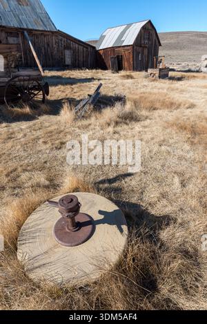 Old grinding wheel in the historic mining town of Bodie, California, USA. Stock Photo
