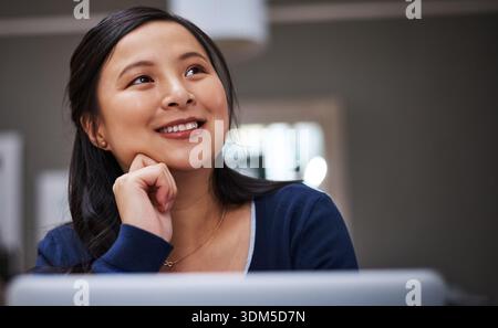 Thinking, laptop and businesswoman in home with planning for freelance creative project. Smile, ideas and Asian magazine editor with brainstorming for Stock Photo