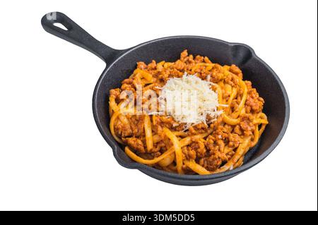 Delicious pasta bolognese with savory meat ragu and parmesan shreds presented in a cast iron skillet on minimalist white background Stock Photo
