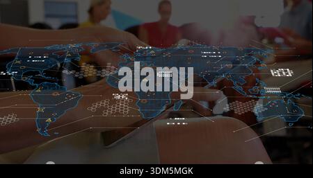 Projecting digital blue world map in meeting, hands holding phone, blurred team wearing bright tops Stock Photo