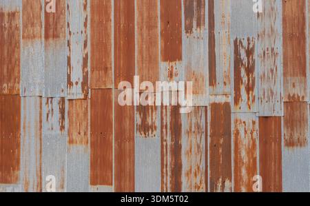 Artistic of old and rusty zinc sheet wall. Vintage style metal sheet roof texture. Pattern of old metal sheet.  Background and texture in retro concep Stock Photo