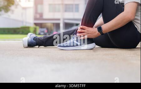 Young adult male with his muscle pain during running. Runner man having leg ache due to Ankle Sprains or Achilles Tendonitis. Sports injuries and medi Stock Photo