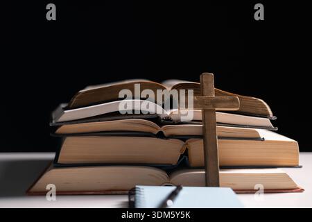 Old library, an open Bible lay on the table, its holy pages of scripture illuminated in the dark room. bible, holy, dark, old, open, library, pages, s Stock Photo