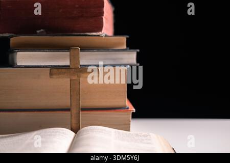 Old library, an open Bible lay on the table, its holy pages of scripture illuminated in the dark room. bible, holy, dark, old, open, library, pages, s Stock Photo