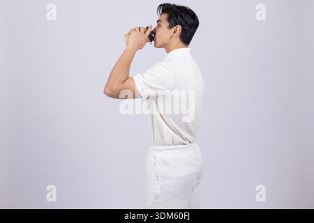 Man in white chef uniform shouting or calling someone Stock Photo