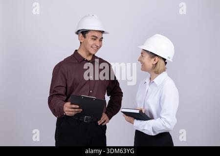 Male and female engineers discussing plan with tablet Stock Photo