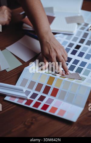 Close up of hands choosing paint colors for interior design project Stock Photo