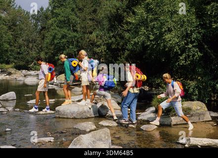 young people have fun outdoor camping doing canoo on camp ground close to river natural environment forest young people group  holidays summer camping Stock Photo