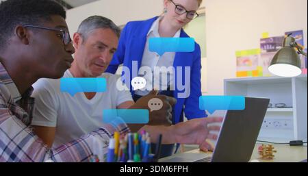 Working three-person team reviewing laptop with chat bubbles at office desk, woman in blue blazer Stock Photo