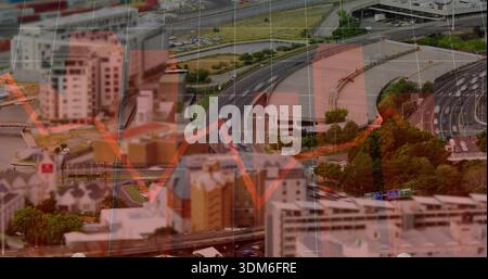 Showing aerial highway interchange curving through urban blocks, with translucent red line graph Stock Photo