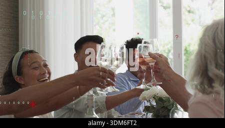 Clinking casually dressed friends and family raising stemmed wine glasses at dining room table Stock Photo