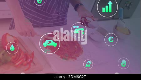 Spreading sauce on dough, teen in striped-apron in kitchen with magenta overlay and green icons Stock Photo