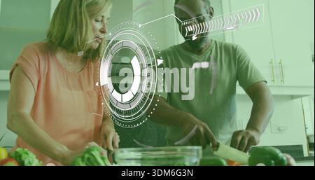 Chopping couple wearing green tee, peach top preparing veggies in kitchen, with HUD and mixing bowl Stock Photo