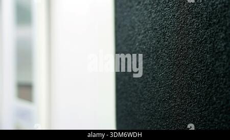 Black grainy texture contrasting with bright white background Stock Photo