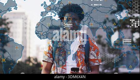 Holding smartphone, man wearing orange shirt backpack and earphones walking city street with AR map Stock Photo
