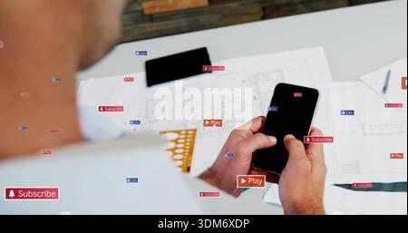 Holding smartphone, man in light shirt checking plans on desk with tablet, stencil and social tags Stock Photo