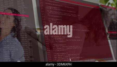 Displaying large monitor showing red code editor at desk, with blouse reflection on glass and plant Stock Photo