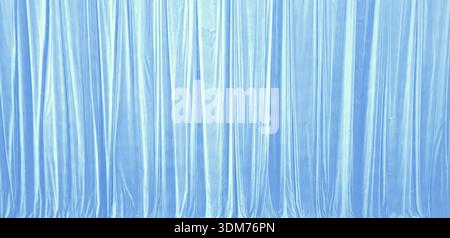Light Blue Silk Curtain Background With Vertical Drapery Folds Stock Photo