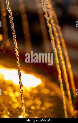 A fountain with blurred streams of water in a night park illuminated by ...