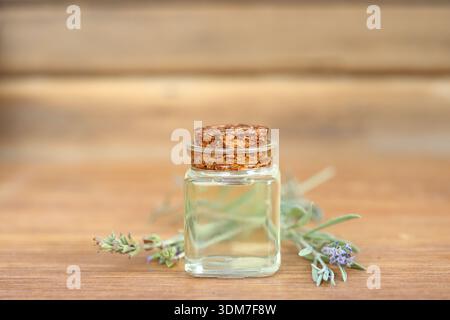 lavender essential oil in glass bottle on wooden background Stock Photo
