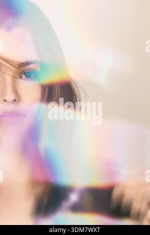 Woman's portrait with soft focus and ethereal light leaks creating a dreamy atmosphere Stock Photo