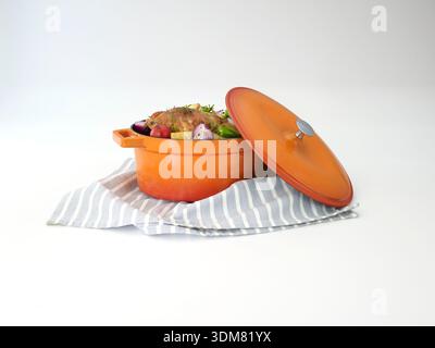 Roasted chicken with vegetables in orange casserole, isolated on white. Stock Photo