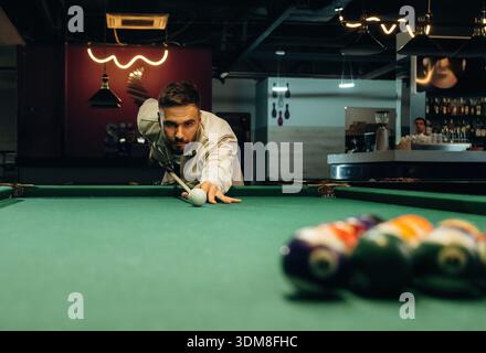 Focused, playing. Handsome man with a pool table game. Stock Photo