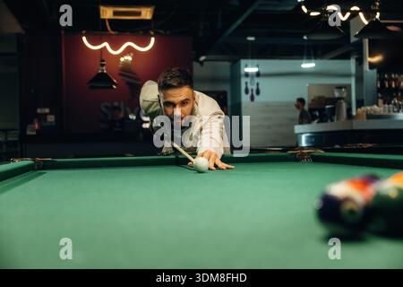 Focused, playing. Handsome man with a pool table game. Stock Photo