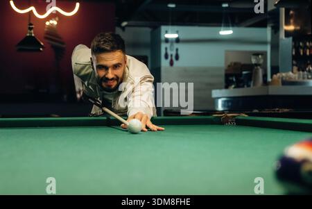 Focused, playing. Handsome man with a pool table game. Stock Photo