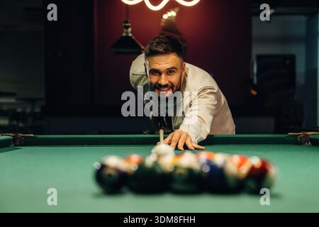 Focused, playing. Handsome man with a pool table game. Stock Photo