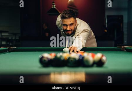 Focused, playing. Handsome man with a pool table game. Stock Photo