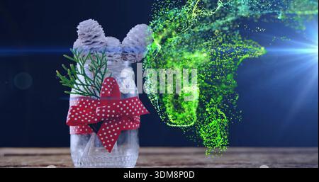 Showing glass jar with three cones sprig polka bow on wood table green-swirl lens-flare, copy space Stock Photo