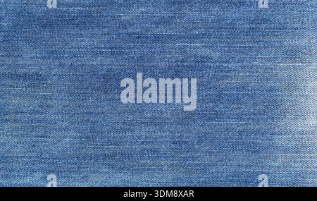 Blue worn denim fabric showing detailed cotton texture lines Stock Photo