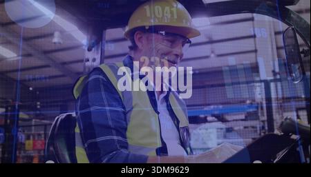 Sitting senior warehouse worker writing on tablet inside cab, hard hat, hi-vis vest, data overlays Stock Photo