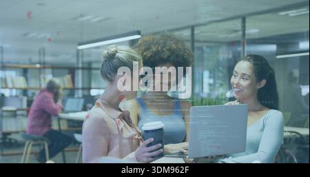 Collaborating three women wearing casual tops reviewing laptop code in open office, with coffee Stock Photo