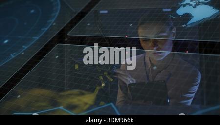 Holding stylus and tablet woman analyst using hologram panels in tech lab wearing lanyard Stock Photo
