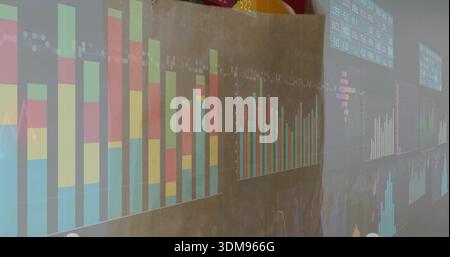 Projecting multi-panel data visuals wall showing analytics in meeting room, with stacked bar charts Stock Photo