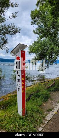 Uberlingen, Germany - June 30, 2024. DLRG SOS pole with solar panel, used for emergency communication on water. The pole is equipped with an SOS butto Stock Photo