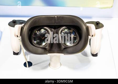 Front view of virtual reality headset with controllers on display showcasing modern VR technology and immersive digital experience Stock Photo