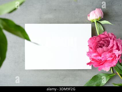 Mock up card with peonies. Invitation card on grey background Stock Photo